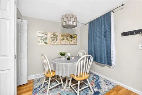 a view of a dining room with furniture and a window