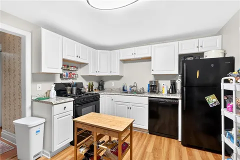 a kitchen with stainless steel appliances granite countertop a refrigerator sink and stove