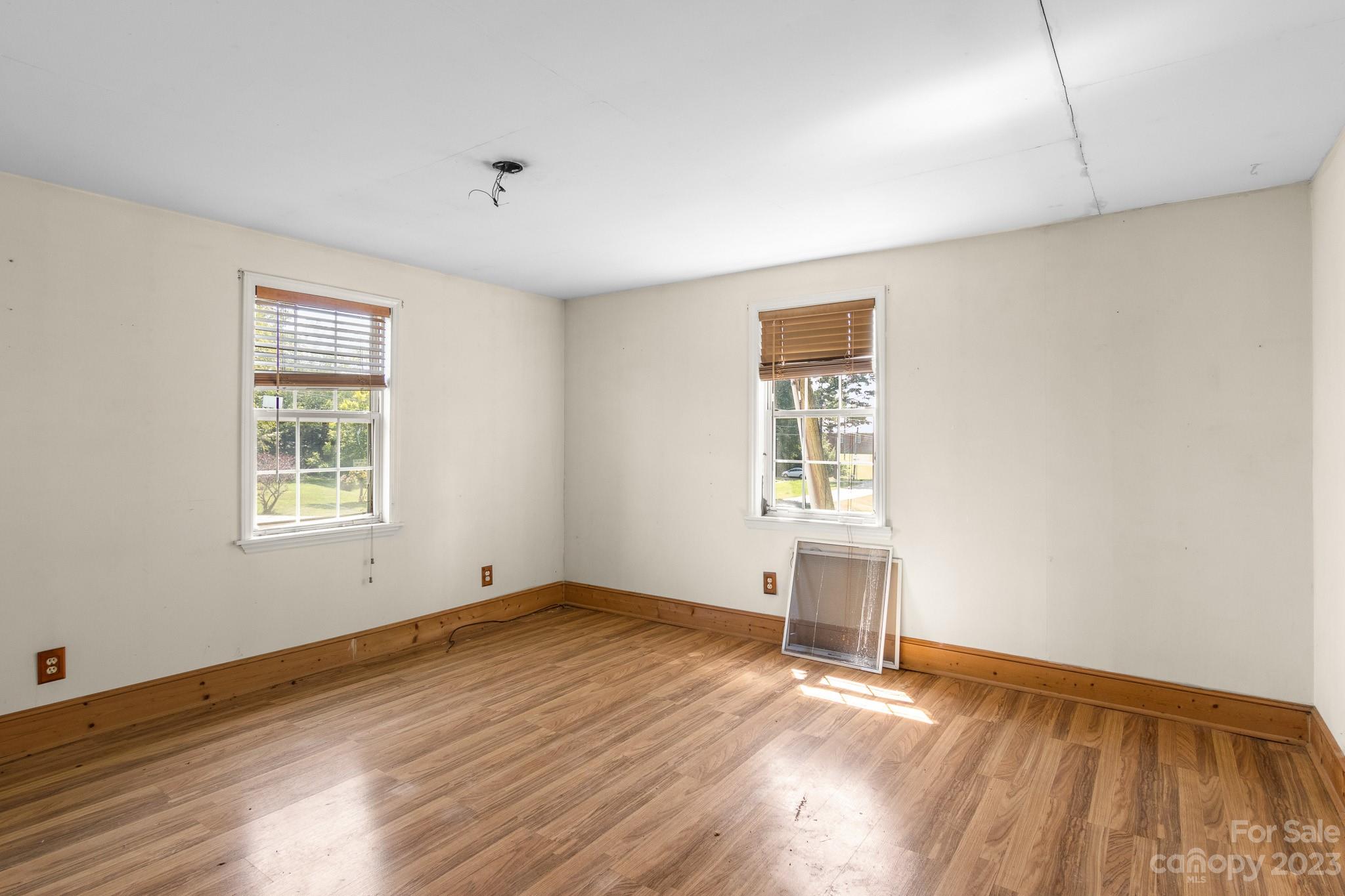 716 Robin Avenue Kannapolis, NC 28081 - Photo 20 of 25 an empty room with wooden floor and windows