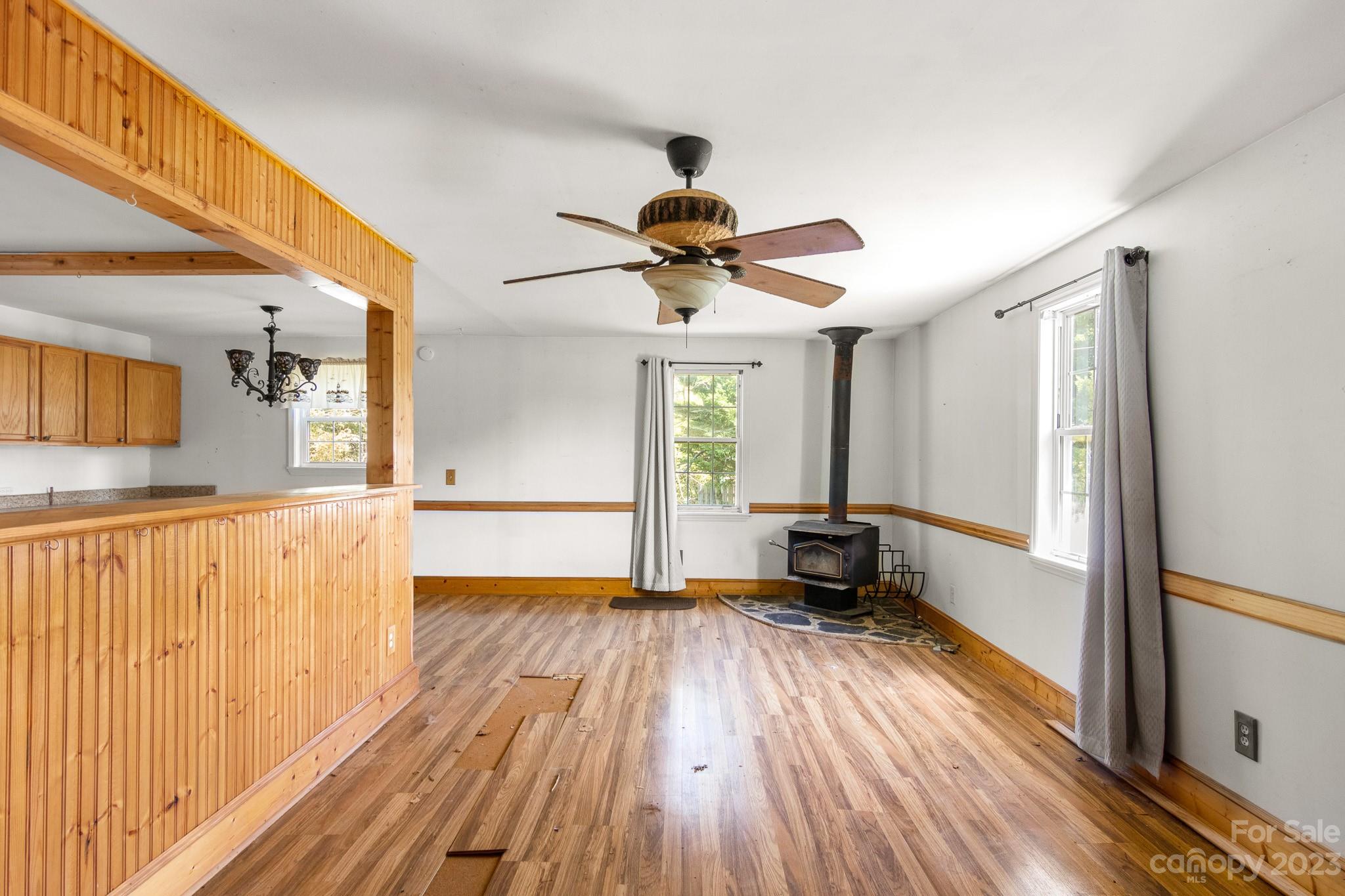 716 Robin Avenue Kannapolis, NC 28081 - Photo 8 of 25 a view of a room with wooden floor a ceiling fan and windows