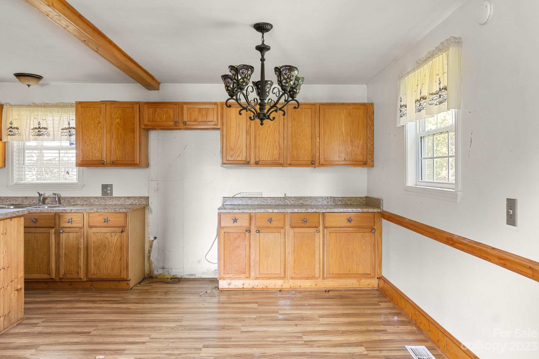 716 Robin Avenue Kannapolis, NC 28081 - Photo 10 of 25 a kitchen with stainless steel appliances granite countertop a sink dishwasher and a granite counter top