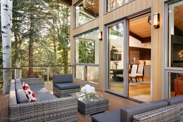 a outdoor living space with furniture and a floor to ceiling window