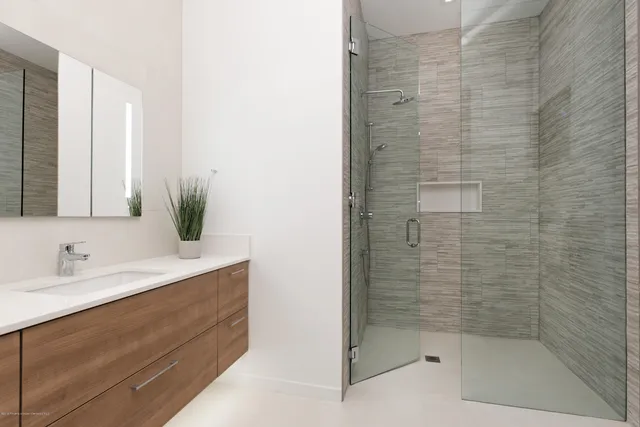 a bathroom with a shower and a sink