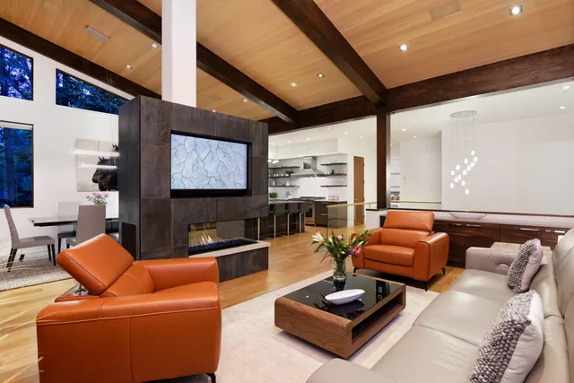 a living room with furniture a rug and a large window