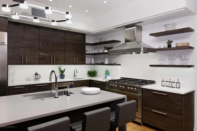 a kitchen with a sink a stove and cabinets