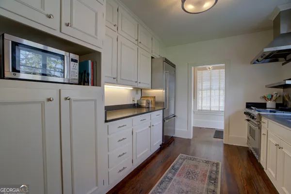 a spacious bedroom with a bed and a chandelier