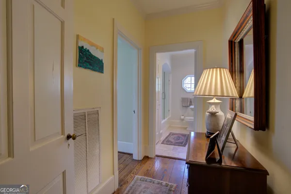 a bedroom with a bed couch and a window