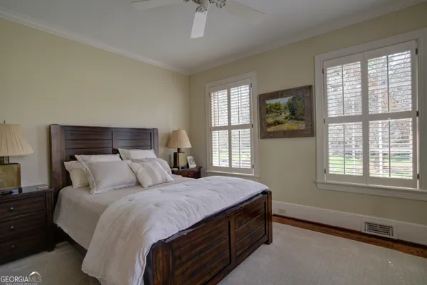 a spacious bedroom with a bed and a chandelier