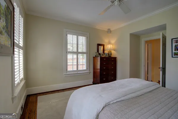 a bathroom with double vanity sink a two mirror a window and a bathtub