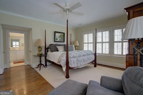 a bedroom with a large bed a flat tv screen and a window