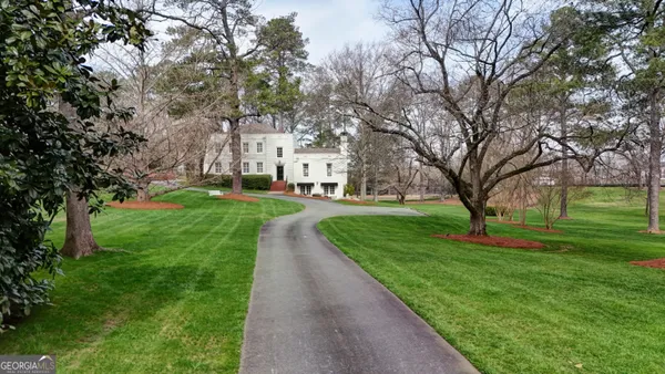 an aerial view of a house with a yard