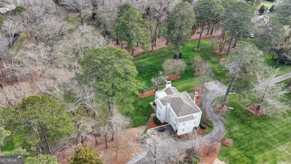 an aerial view of a house with a yard