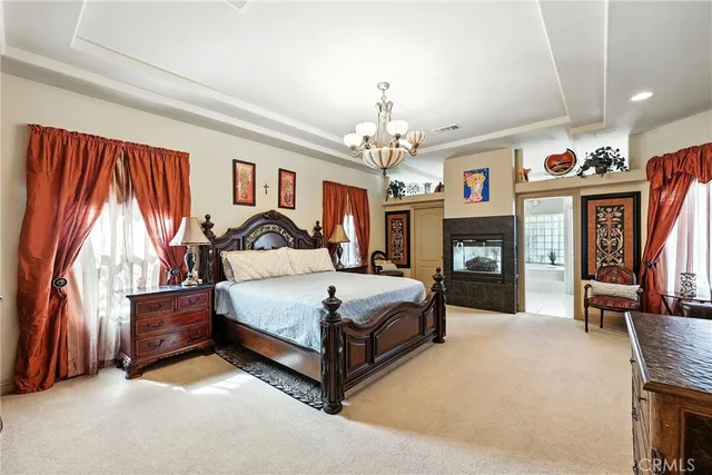 a spacious bedroom with a bed and a large mirror