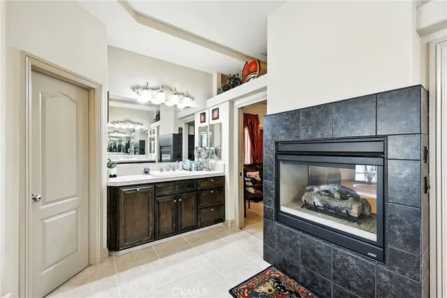 a bedroom with a bed and a walk in closet with wooden floor