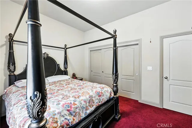 a bedroom with bed and a window