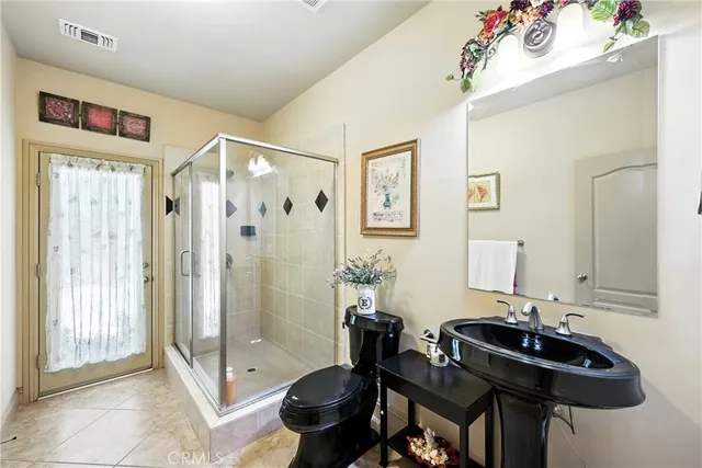 a bed room with a bed and a chair