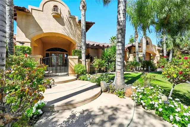 a backyard of a house with a garden and outdoor seating