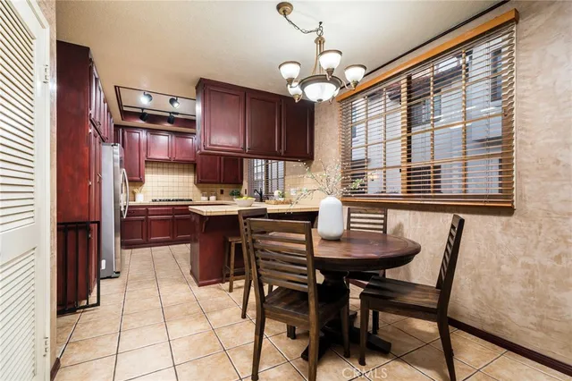 a kitchen with stainless steel appliances kitchen island granite countertop a sink and cabinets