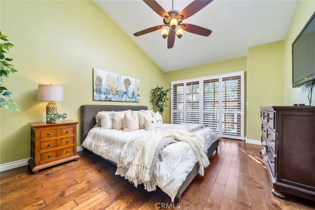 a spacious bedroom with a bed and a chandelier