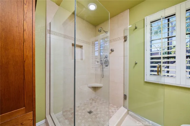 a bathroom with a shower and a sink