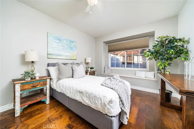 a bedroom with a bed and a potted plant