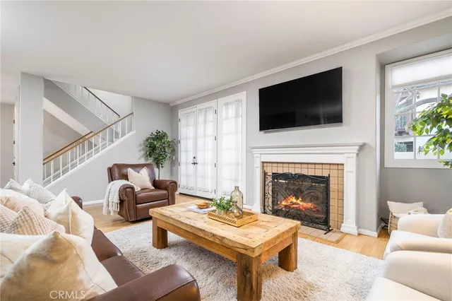 a living room with furniture a flat screen tv and a fireplace