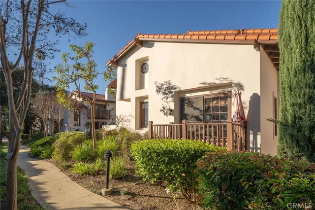a view of a house with a small yard and plants