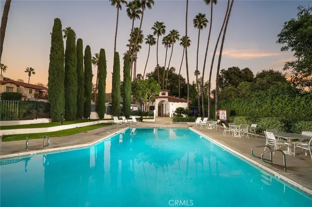 a view of building with yard and swimming pool