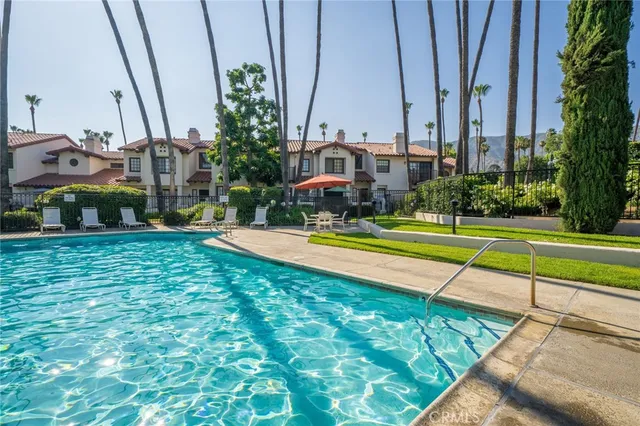 a view of a park that has large trees and a sign board