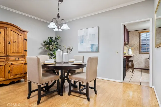 a view of a dining room with furniture and chandelier