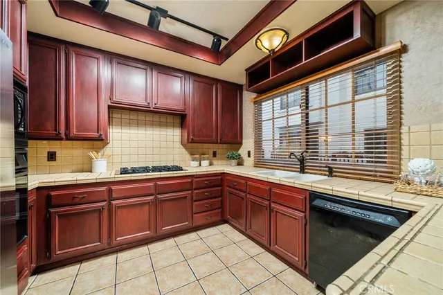a kitchen with wooden cabinets and sink
