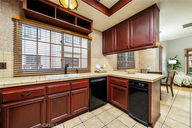 a kitchen with stainless steel appliances granite countertop wooden cabinets a sink and a stove