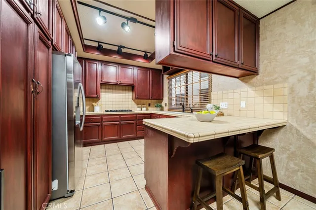 a kitchen with stainless steel appliances granite countertop a sink and cabinets