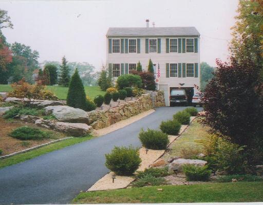 a view of a house with backyard and sitting area