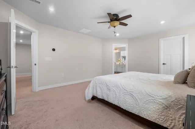 a bedroom with a bed and a ceiling fan