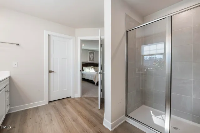 a view of a bathroom that has a glass shower door