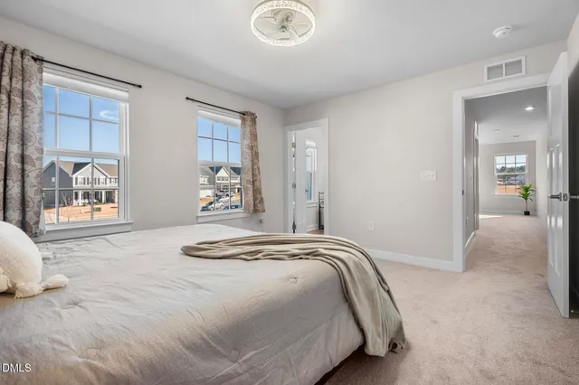 a bedroom with a bed and a large window