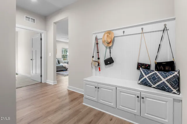 a view of a storage and utility room with wooden floor