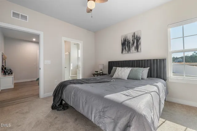 a bedroom with bed and window