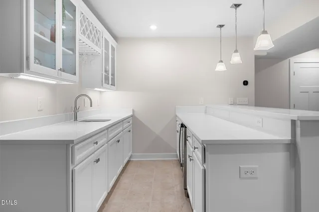 a kitchen with cabinets and chairs