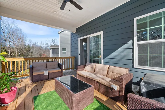 a outdoor living room with furniture and a floor to ceiling window