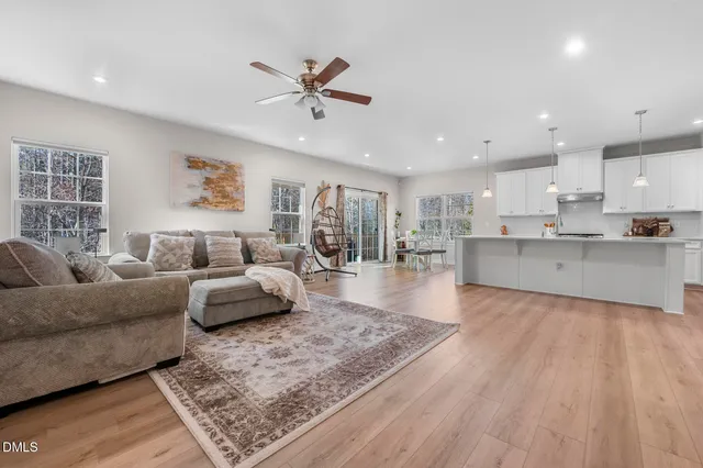 a living room with furniture and kitchen view
