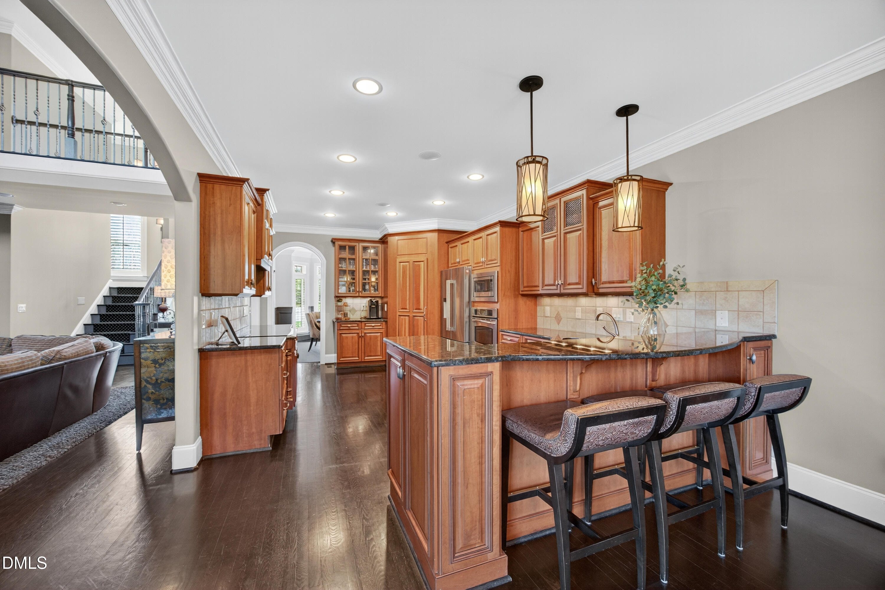 4900 Robdot Drive Oak Ridge, NC 27310 - Photo 14 of 58 a dining table chairs wooden floor and kitchen view