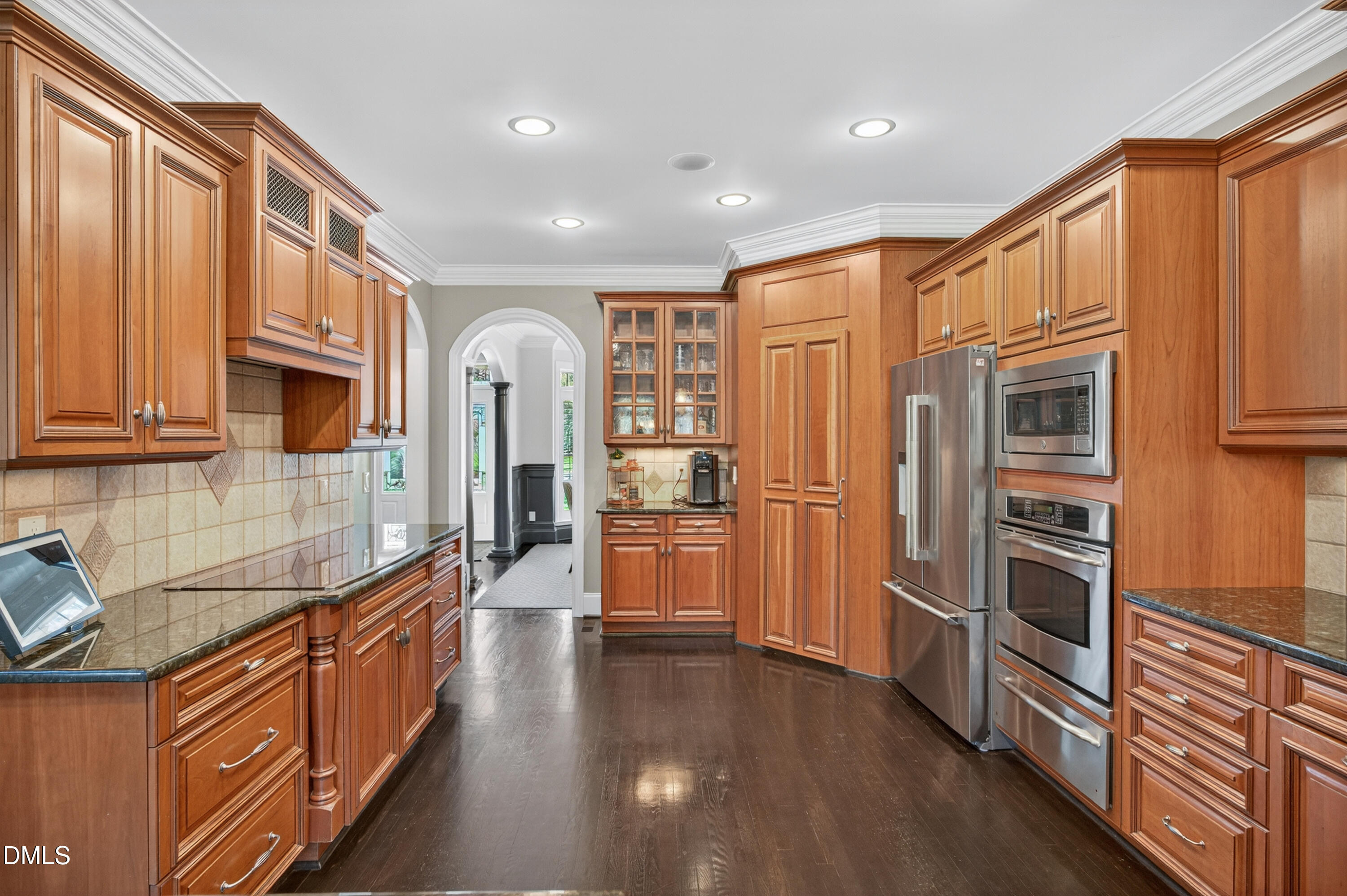 4900 Robdot Drive Oak Ridge, NC 27310 - Photo 16 of 58 a kitchen with stainless steel appliances granite countertop a refrigerator a stove and a wooden cabinets