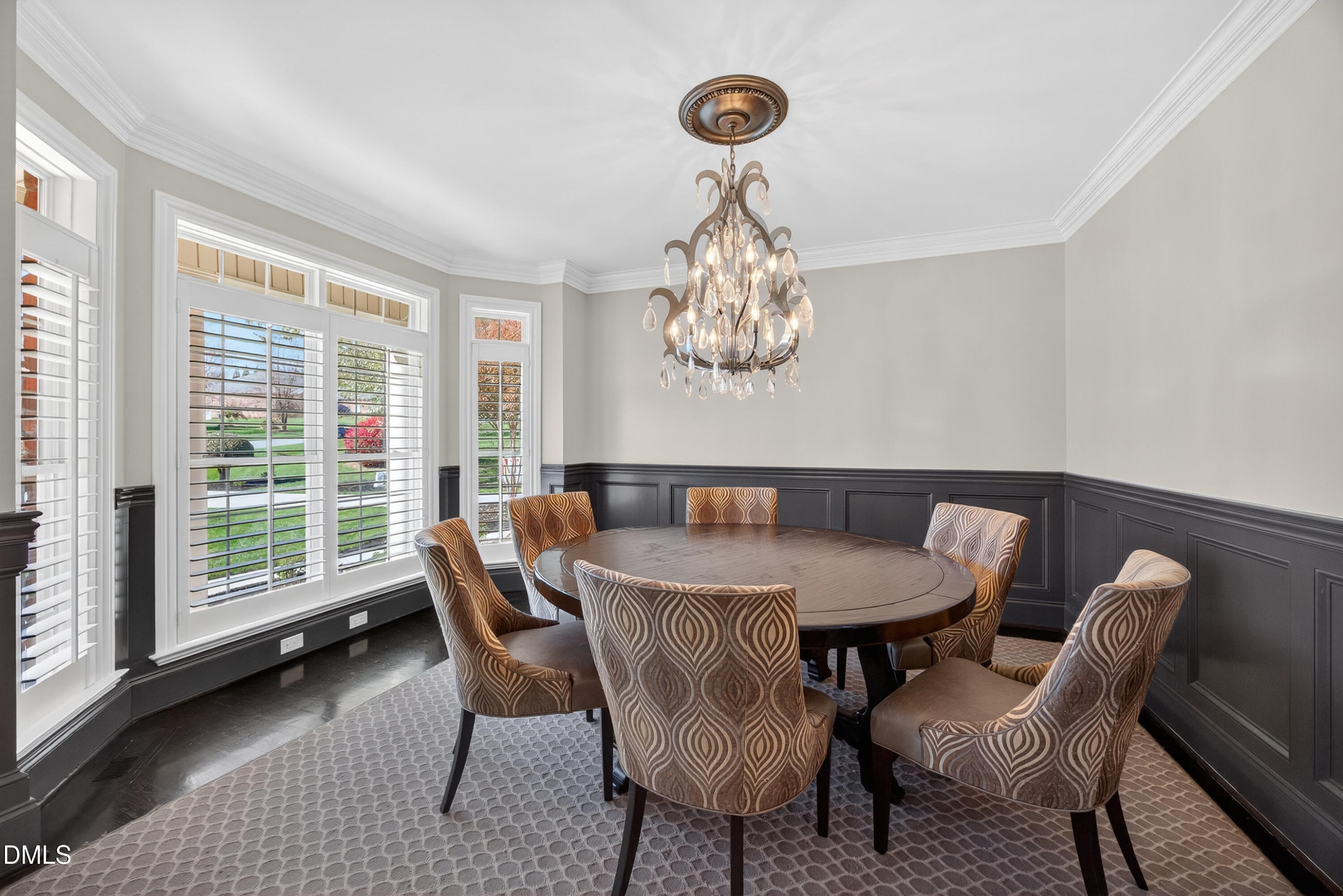 4900 Robdot Drive Oak Ridge, NC 27310 - Photo 18 of 58 a dining room with furniture a chandelier and wooden floor