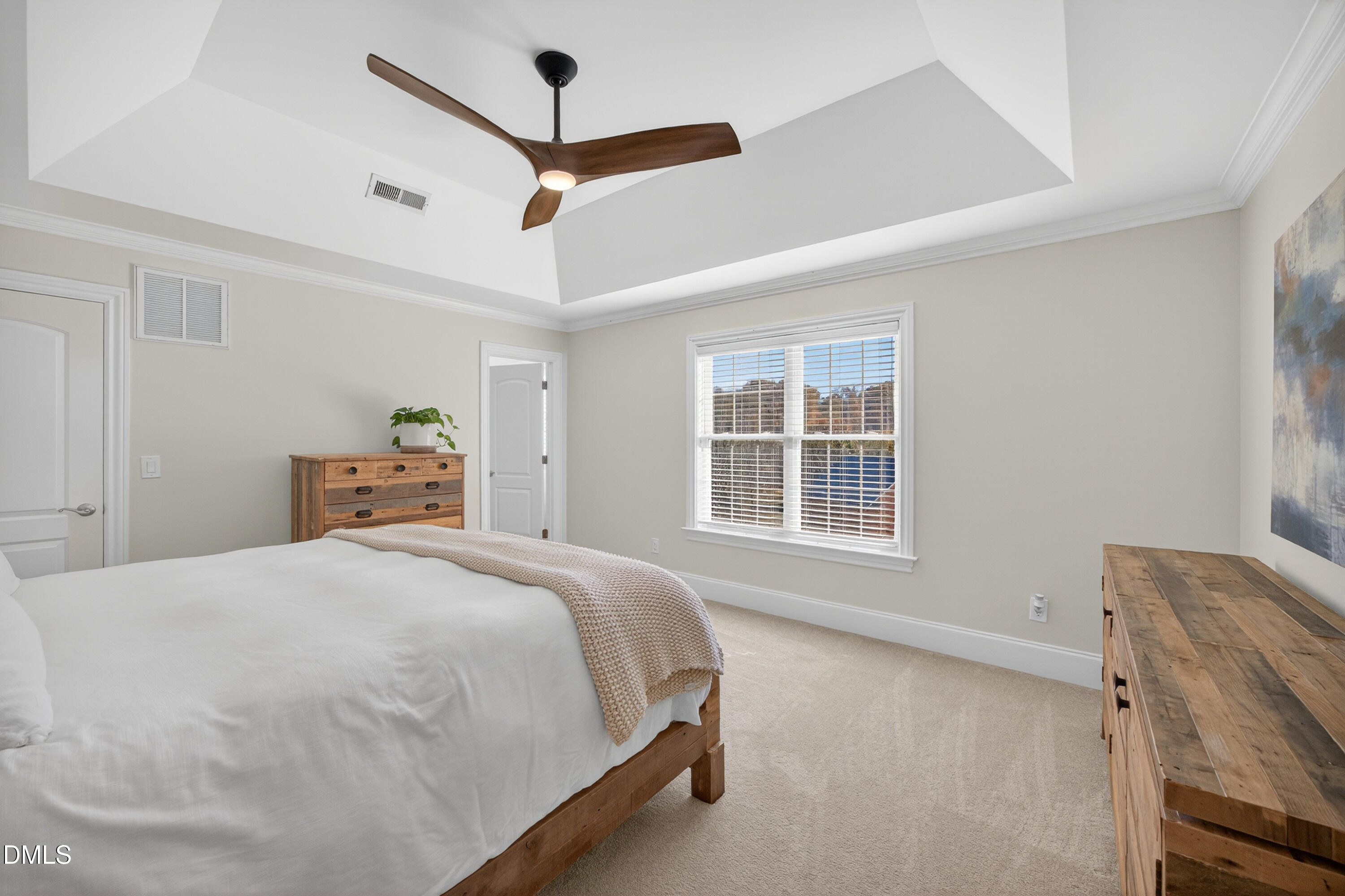 4900 Robdot Drive Oak Ridge, NC 27310 - Photo 28 of 58 a spacious bedroom with a bed and a window