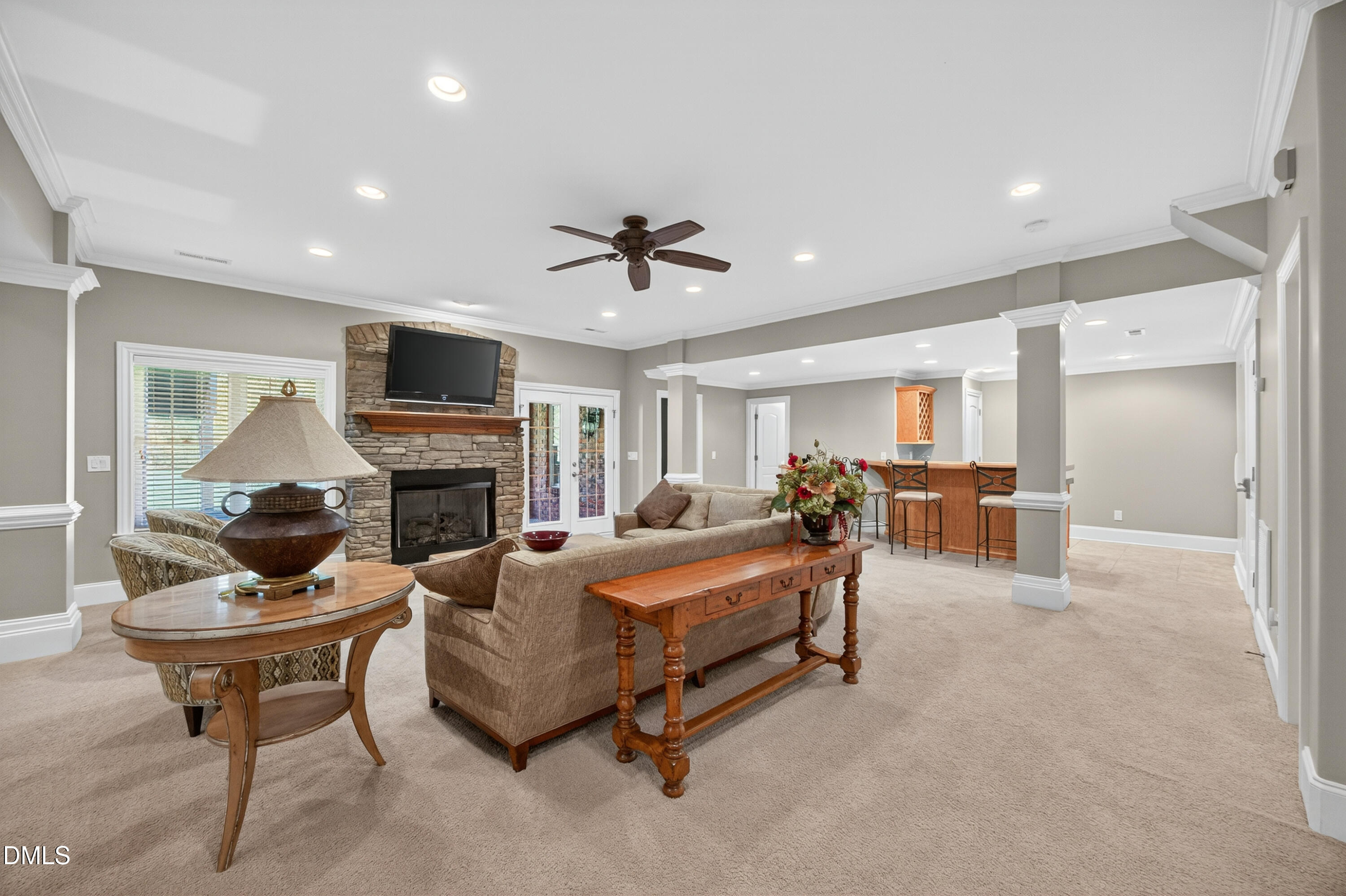 4900 Robdot Drive Oak Ridge, NC 27310 - Photo 35 of 58 a living room with furniture a fireplace and a flat screen tv