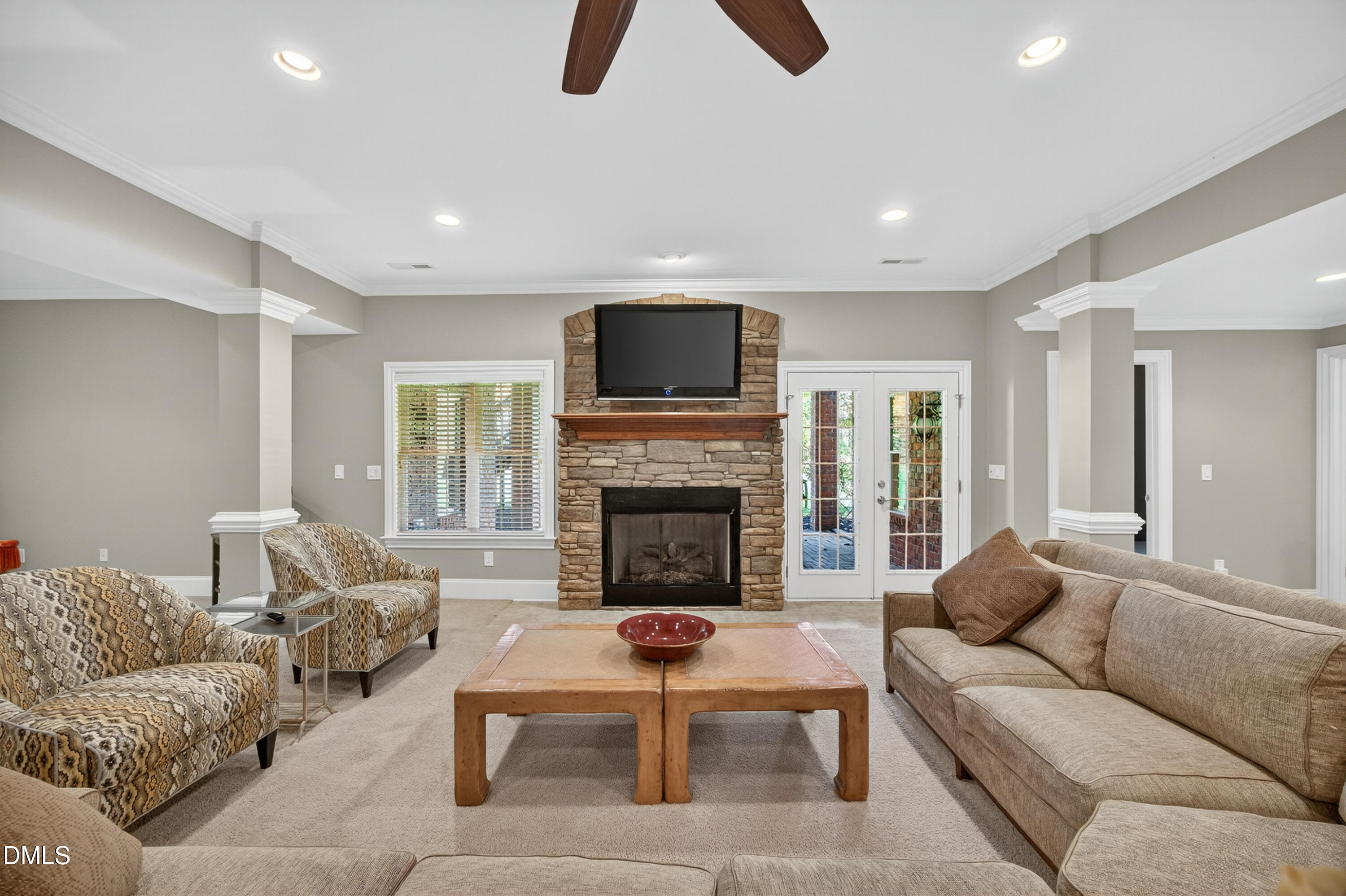 4900 Robdot Drive Oak Ridge, NC 27310 - Photo 36 of 58 a living room with furniture a flat screen tv and a fireplace