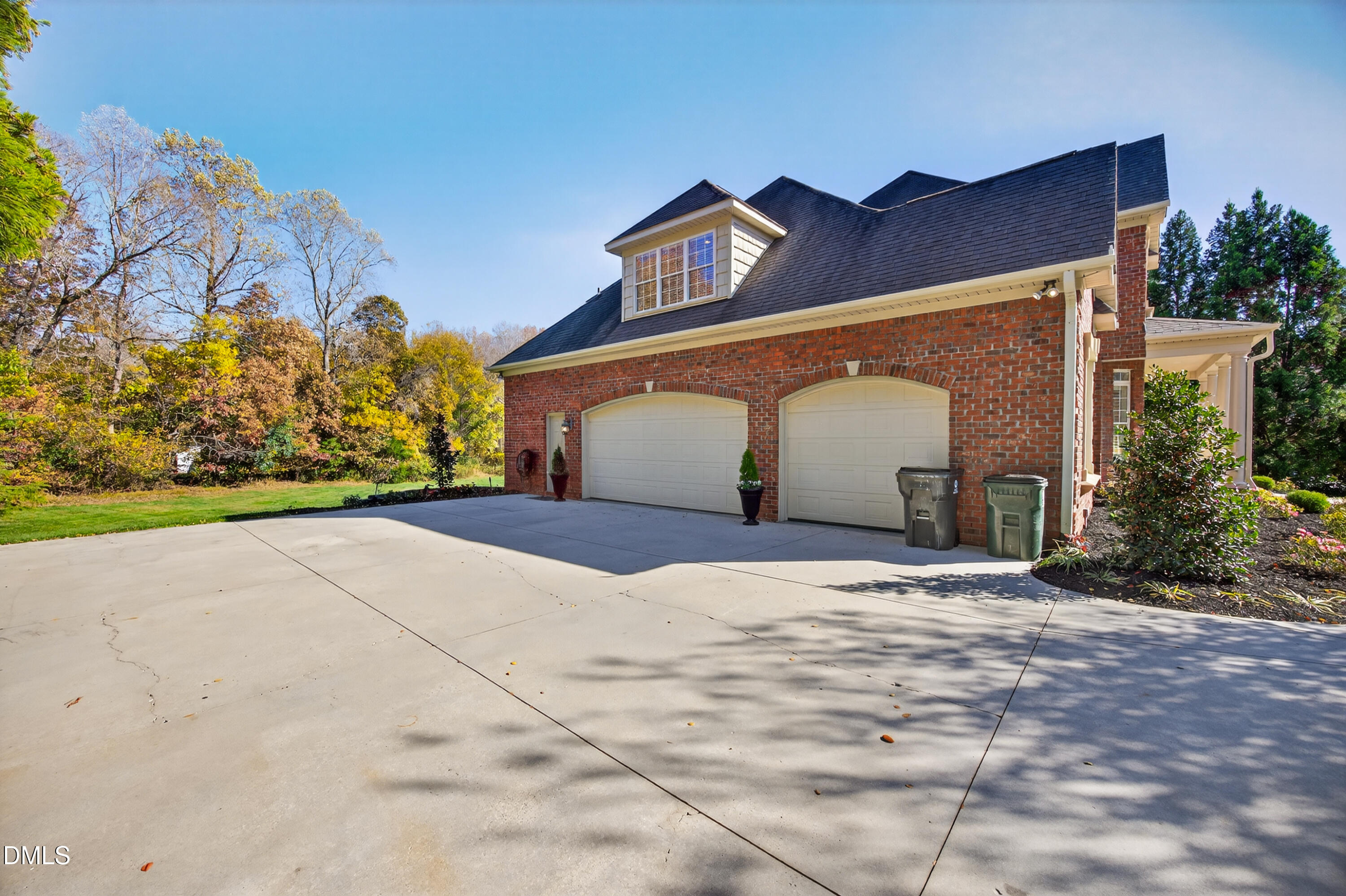 4900 Robdot Drive Oak Ridge, NC 27310 - Photo 44 of 58 a front view of a house with a yard and garage