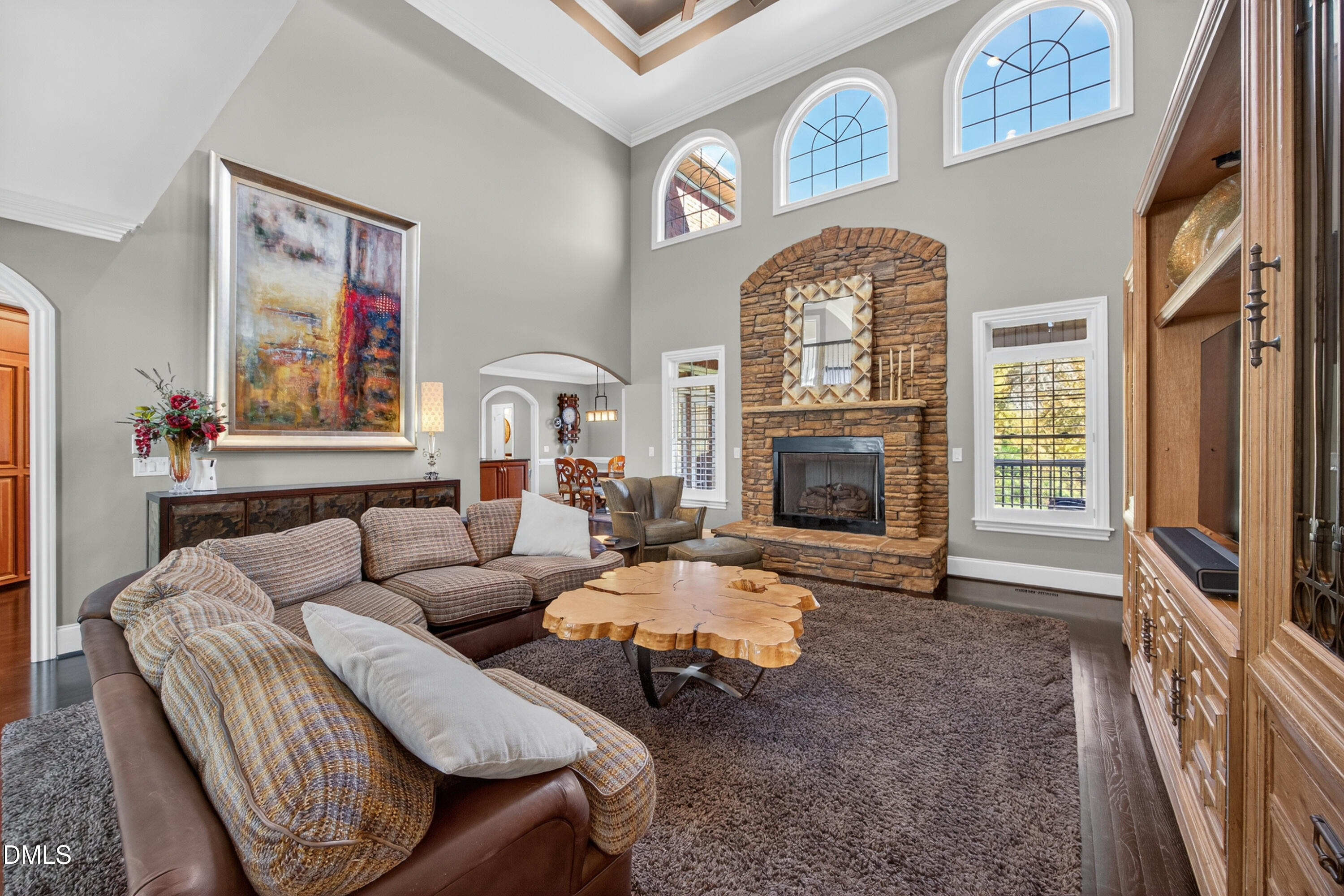 4900 Robdot Drive Oak Ridge, NC 27310 - Photo 9 of 58 a living room with furniture a fireplace and a flat screen tv